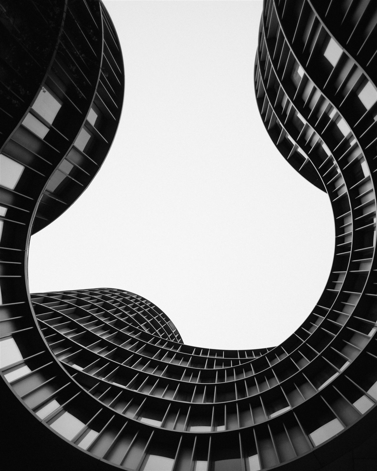 Curved modern building facade seen from below